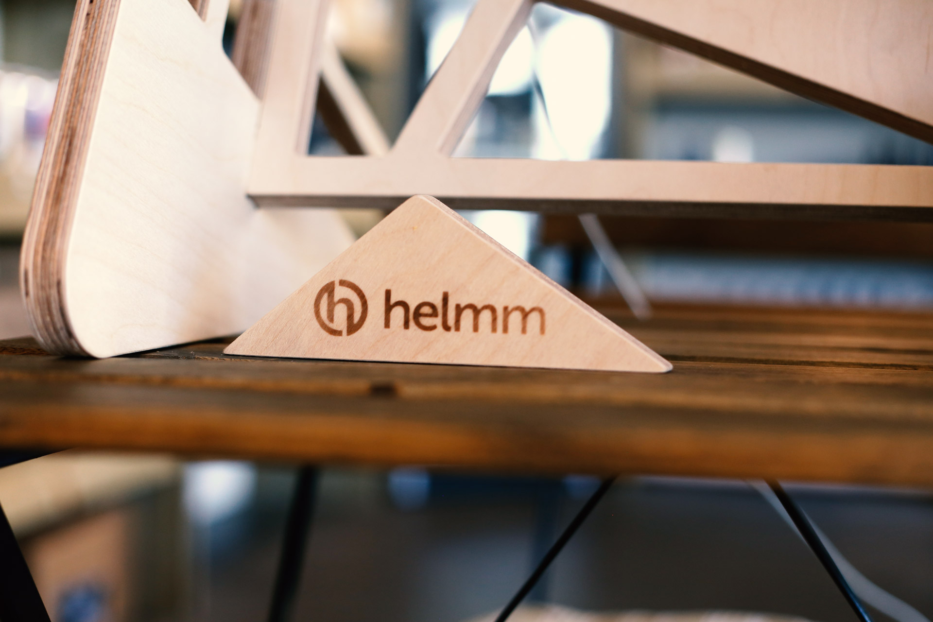 Helmm logo branded onto plywood desk accessory