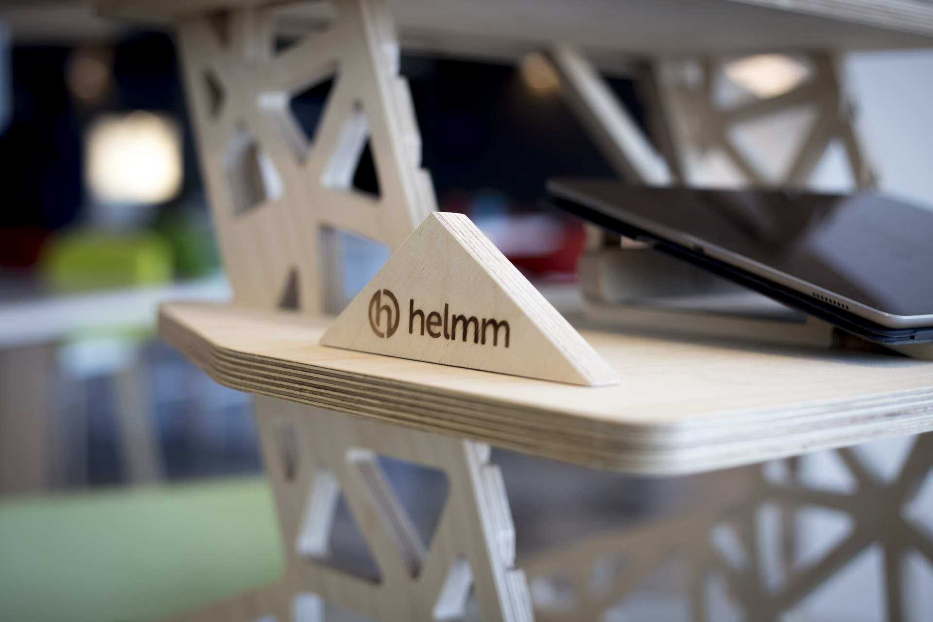 Helmm logo branded onto standing desk accessory